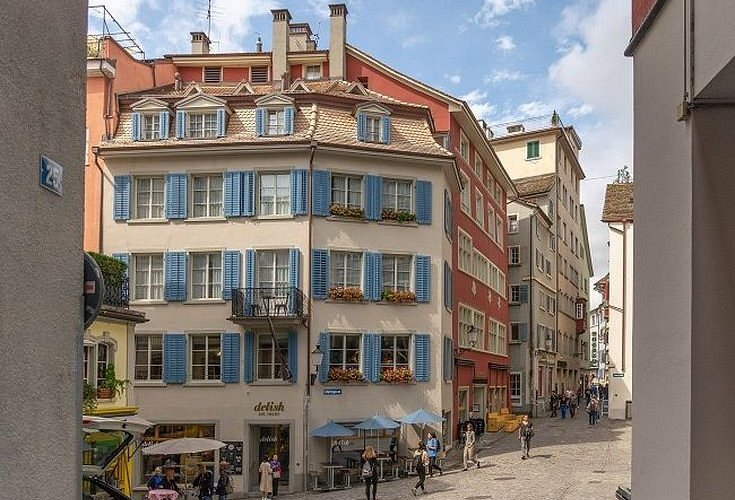 Tall narrow house on a paved lane in an old town quarter